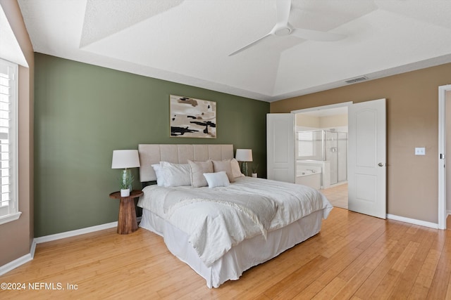 bedroom featuring hardwood / wood-style floors, ceiling fan, and connected bathroom