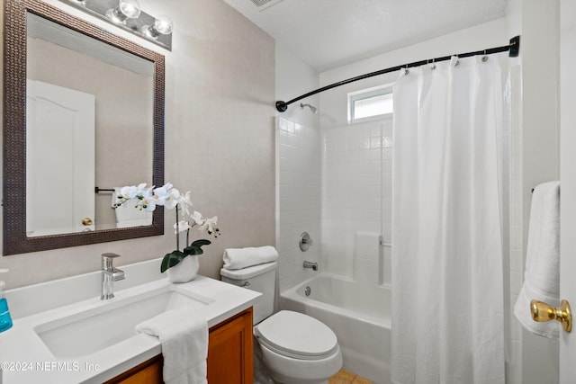 full bathroom with a textured ceiling, vanity, toilet, and shower / bath combo