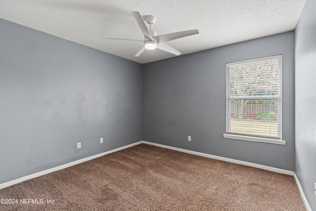 spare room with carpet, ceiling fan, and a textured ceiling