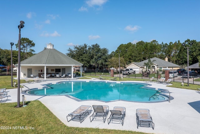 view of swimming pool with a lawn and a patio area