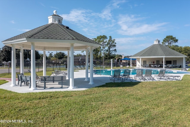 view of swimming pool with a gazebo and a lawn