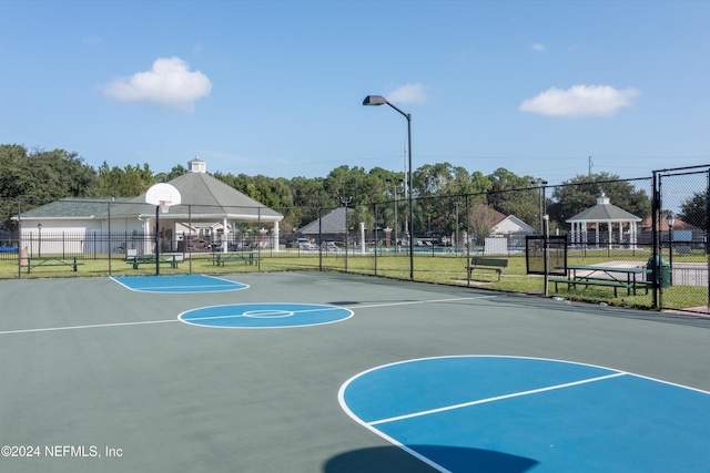 view of basketball court with a gazebo and a lawn