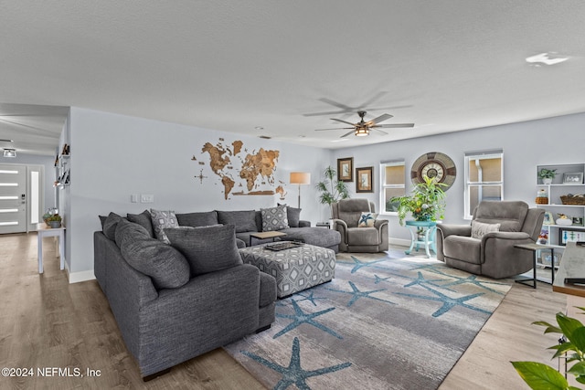 living room with ceiling fan and wood-type flooring