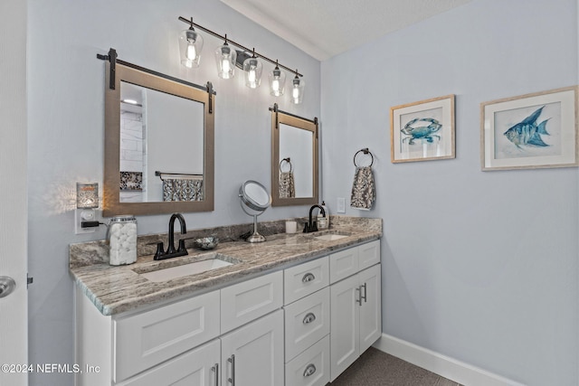 bathroom with a textured ceiling and vanity