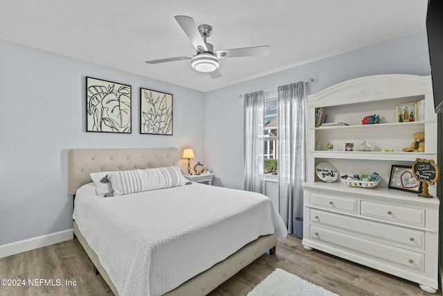 bedroom featuring dark hardwood / wood-style floors and ceiling fan