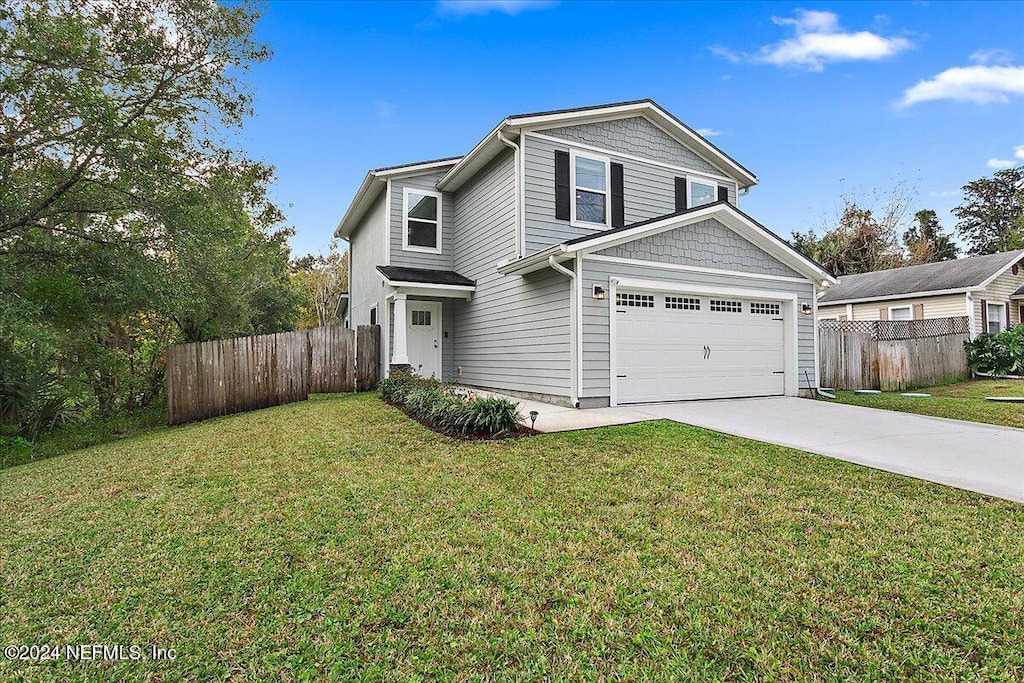 front of property featuring a front yard and a garage