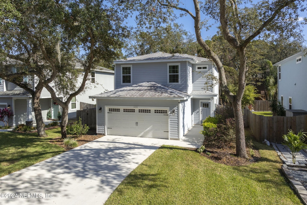 front facade featuring a front lawn and a garage