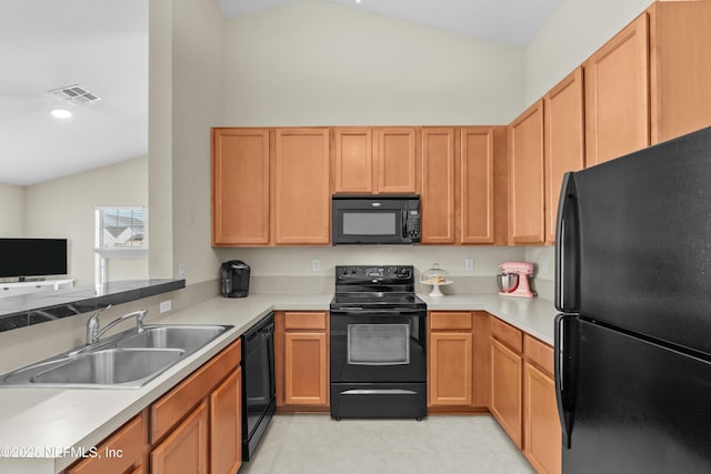 kitchen featuring sink, vaulted ceiling, light tile patterned floors, kitchen peninsula, and black appliances