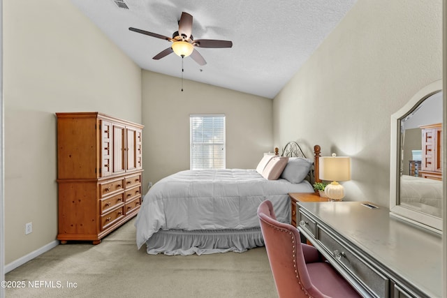 carpeted bedroom featuring vaulted ceiling, ceiling fan, and a textured ceiling