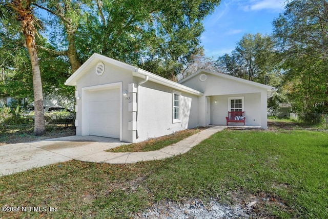 ranch-style home with a front lawn and a garage