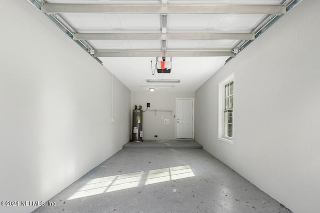 garage with a garage door opener and water heater