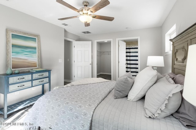 bedroom with a closet, a spacious closet, and ceiling fan