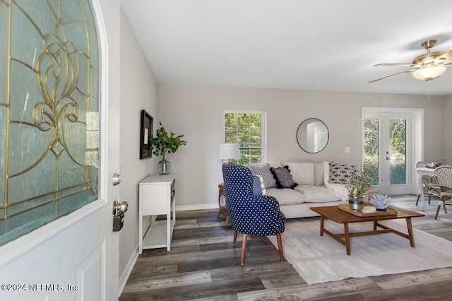 living room featuring ceiling fan, plenty of natural light, dark wood-type flooring, and french doors