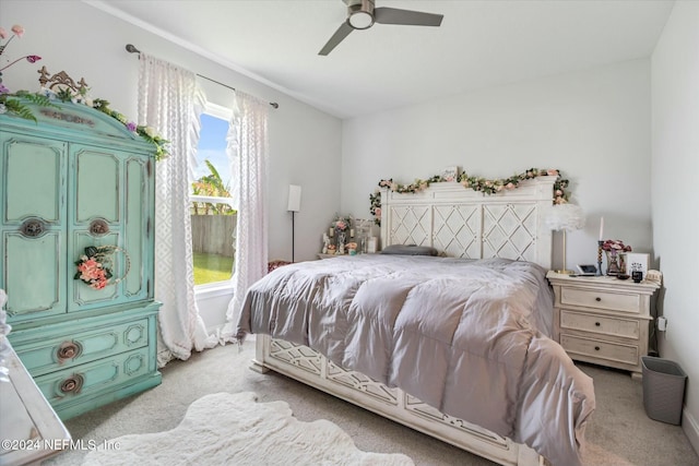 bedroom with ceiling fan and light colored carpet