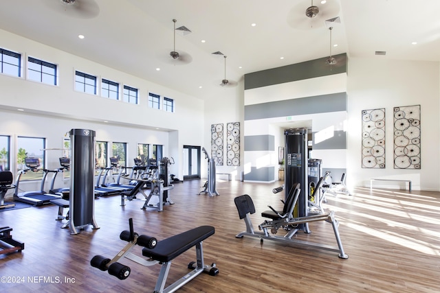 workout area featuring ceiling fan, visible vents, wood finished floors, and recessed lighting