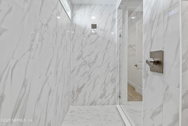 full bath with a marble finish shower