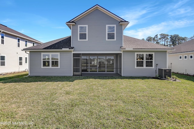 back of house featuring a shingled roof, central AC, and a yard