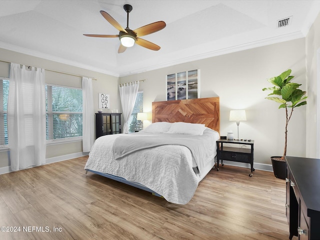 bedroom featuring light wood-type flooring, ceiling fan, and ornamental molding