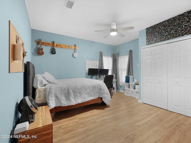 bedroom featuring ceiling fan, a closet, and wood-type flooring