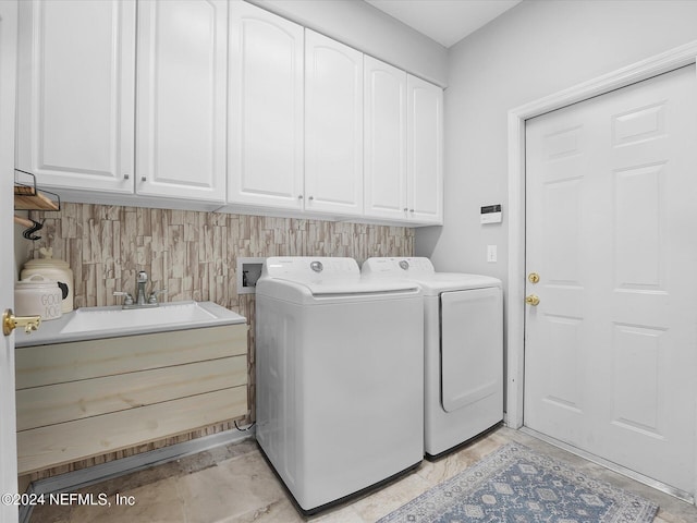 laundry room with cabinets, sink, and washing machine and clothes dryer