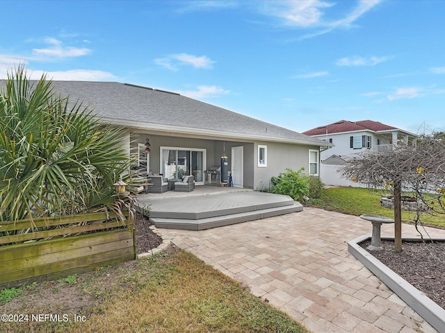 back of house with an outdoor living space and a wooden deck