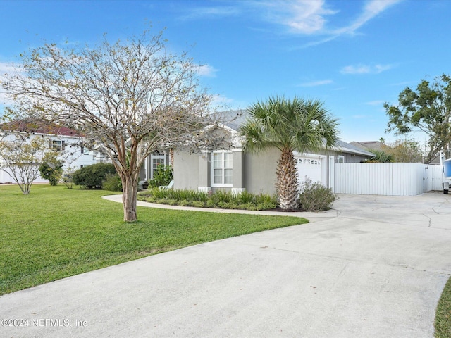 ranch-style house with a garage and a front yard