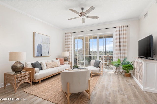 living room featuring light hardwood / wood-style flooring, ceiling fan, and ornamental molding