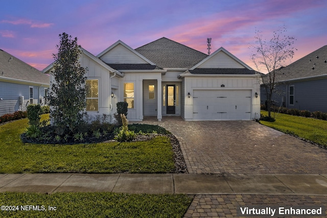 view of front of house featuring a yard and a garage