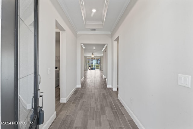 hall with hardwood / wood-style floors and ornamental molding