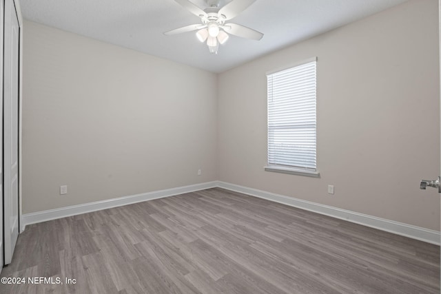 unfurnished room with ceiling fan and light hardwood / wood-style flooring