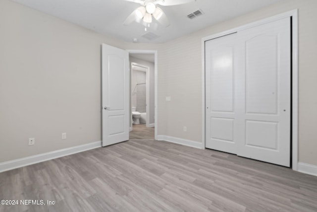 unfurnished bedroom with ceiling fan, a closet, and light wood-type flooring