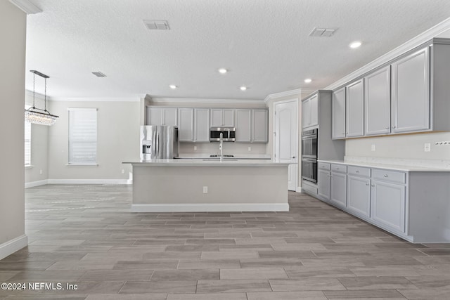 kitchen featuring gray cabinets, stainless steel appliances, and ornamental molding