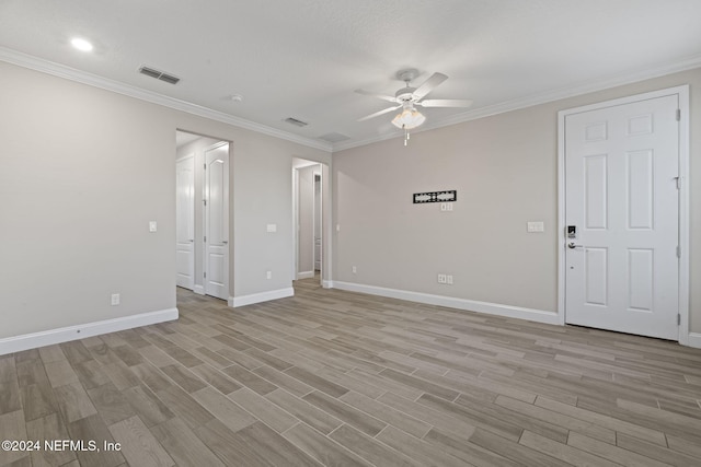 spare room with light wood-type flooring, ceiling fan, and ornamental molding