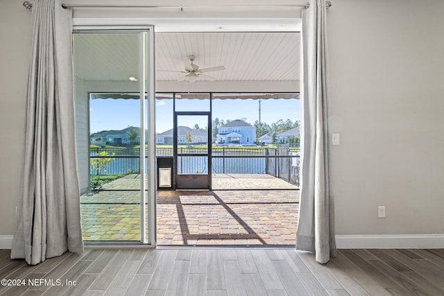 entryway featuring a water view, plenty of natural light, light hardwood / wood-style floors, and ceiling fan