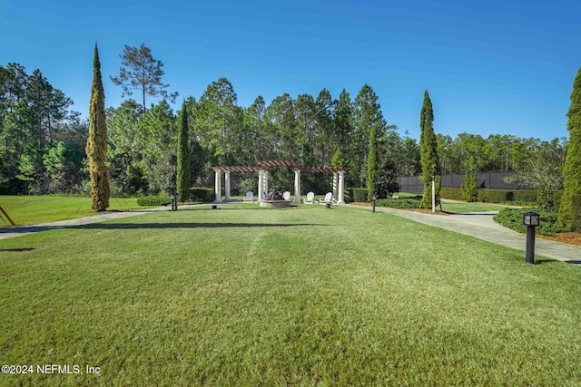 view of home's community with a lawn and a pergola