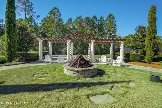 exterior space with a fire pit, a pergola, and a lawn