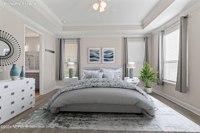 bedroom featuring ensuite bathroom, dark hardwood / wood-style flooring, ceiling fan, and ornamental molding