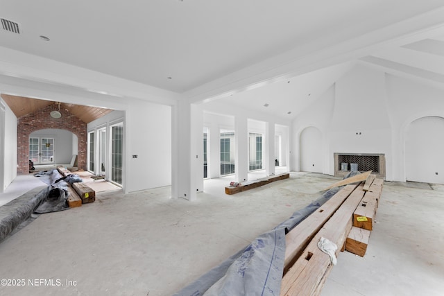 living room with beamed ceiling and high vaulted ceiling