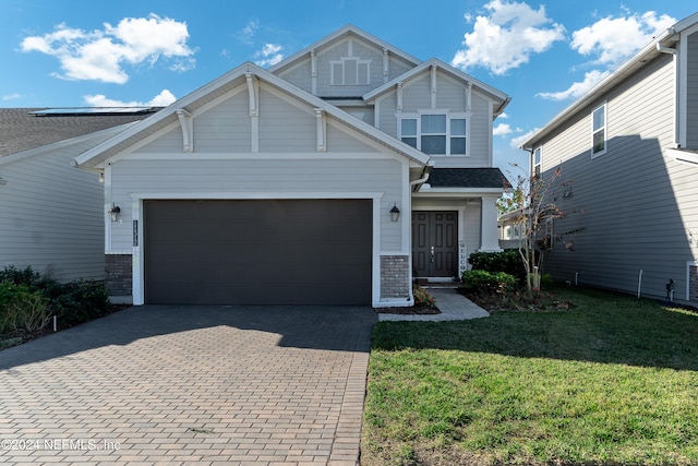 view of front facade with a garage and a front lawn