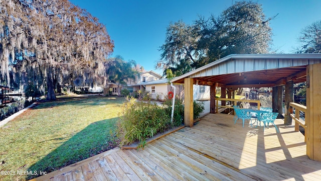 wooden deck featuring a lawn