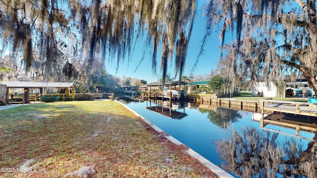 view of dock featuring a yard and a water view