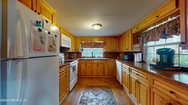 kitchen featuring white appliances and sink