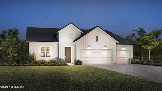 modern farmhouse style home featuring a garage and a front lawn