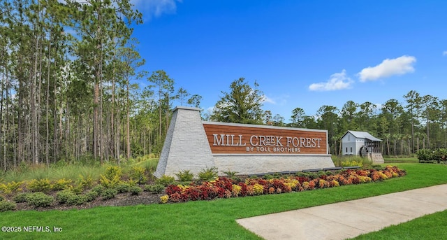 community sign featuring a lawn