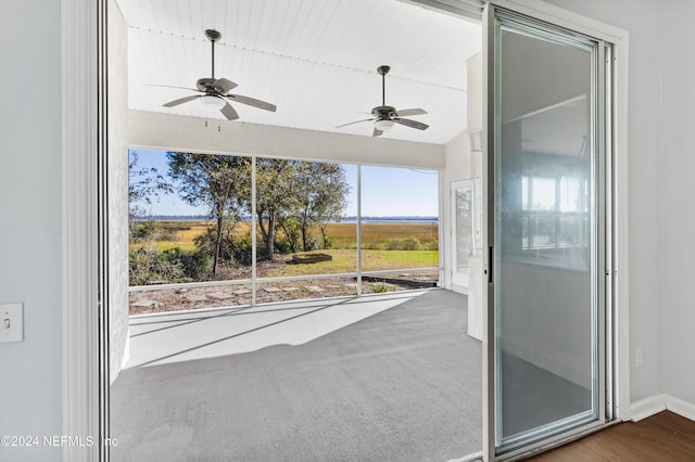 unfurnished sunroom featuring plenty of natural light and ceiling fan