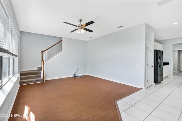 living room featuring light hardwood / wood-style flooring and ceiling fan