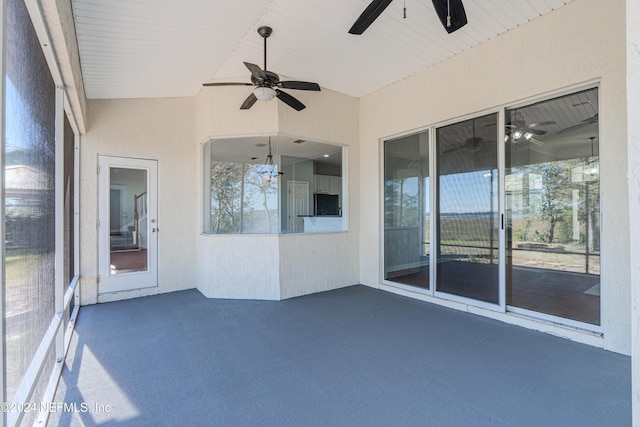 unfurnished sunroom with plenty of natural light, ceiling fan, and vaulted ceiling