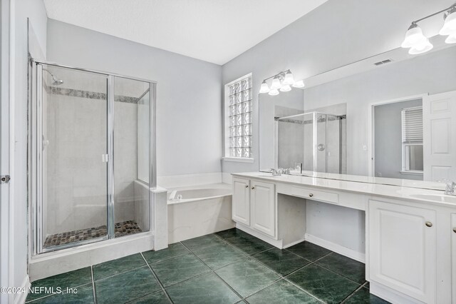 bathroom featuring tile patterned floors, vanity, and shower with separate bathtub