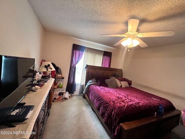 carpeted bedroom with a textured ceiling and ceiling fan