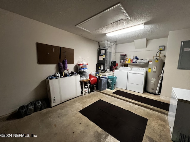 garage featuring washing machine and dryer, electric water heater, electric panel, and heating unit